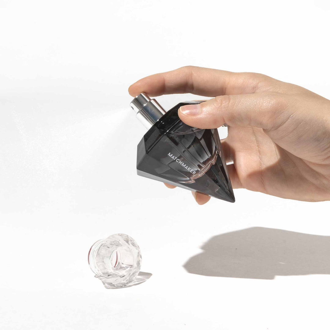 Hand holding Eye of Love Matchmaker pheromone cologne