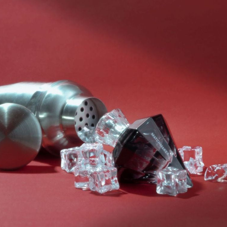 Eye of Love Black Diamond pheromone parfum displayed with a cocktail shaker and ice cubes