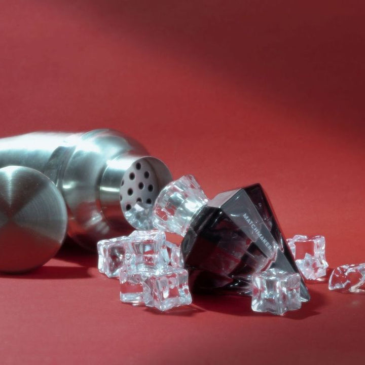 Eye of Love Black Diamond pheromone parfum displayed with a cocktail shaker and ice cubes