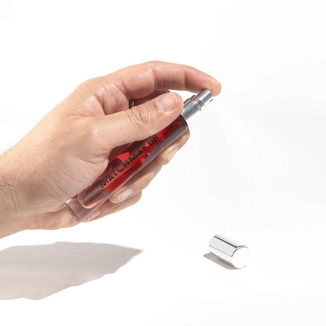 Hand holding Eye of Love Matchmaker Red Diamond pheromone parfum